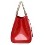 Sac à main originale verni rouge avec décor en métal, vue de profil