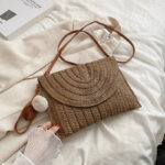 Sac à main pochette élégant en paille sur un tissus blanc