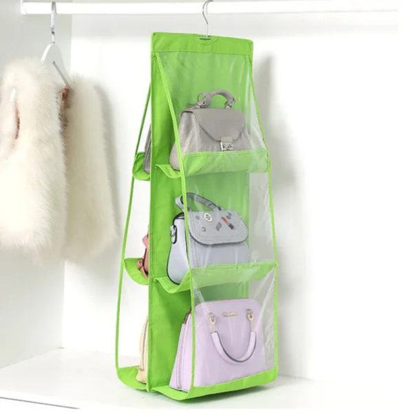 Rangement sac à main pratique en six compartiments, de couleur verte et transparente accroché dans une armoire