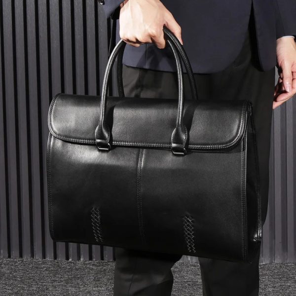 sac-main-homme-cuir-noir-chic-sophistique-02 Sac à main homme cuir noir chic et sophistiqué tenu à la main